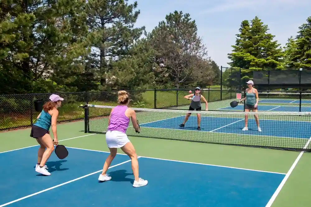 4 players playing doubles pickleball